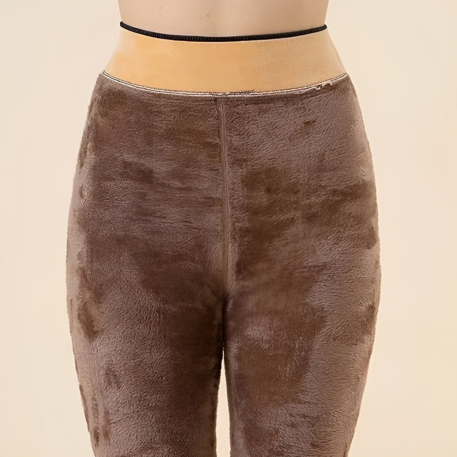 Brown textured leggings worn by a person on a beige background