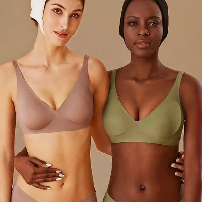 Two women wearing different colored bras against a beige background