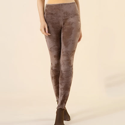 Brown leggings worn by a person on a beige background